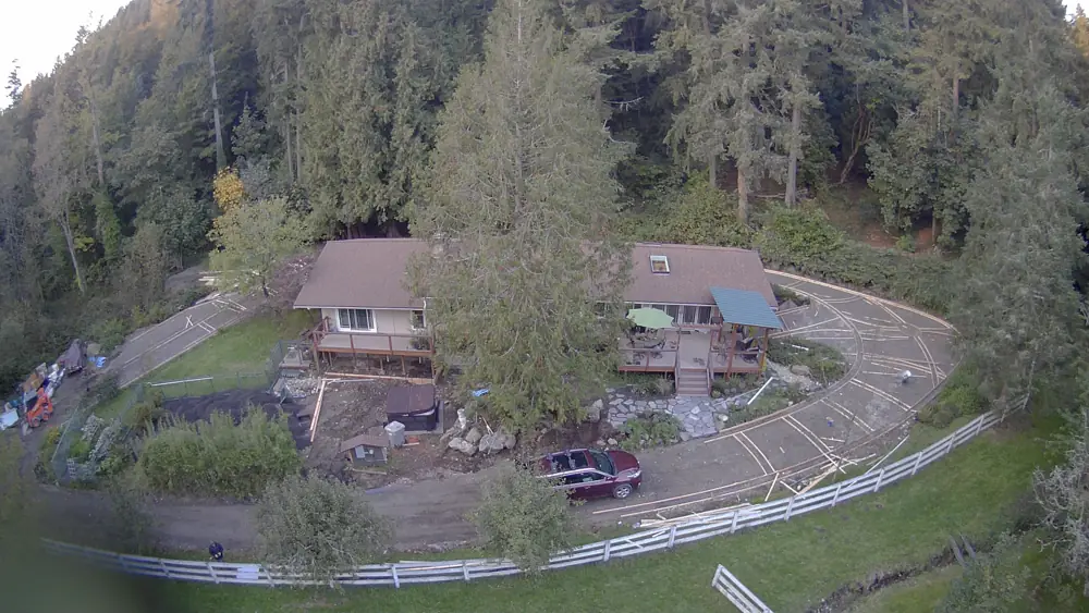 Aerial view of a property with a curved driveway