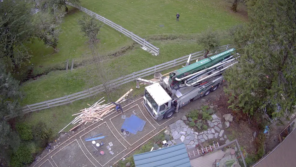 A pump truck delivering concrete to the site