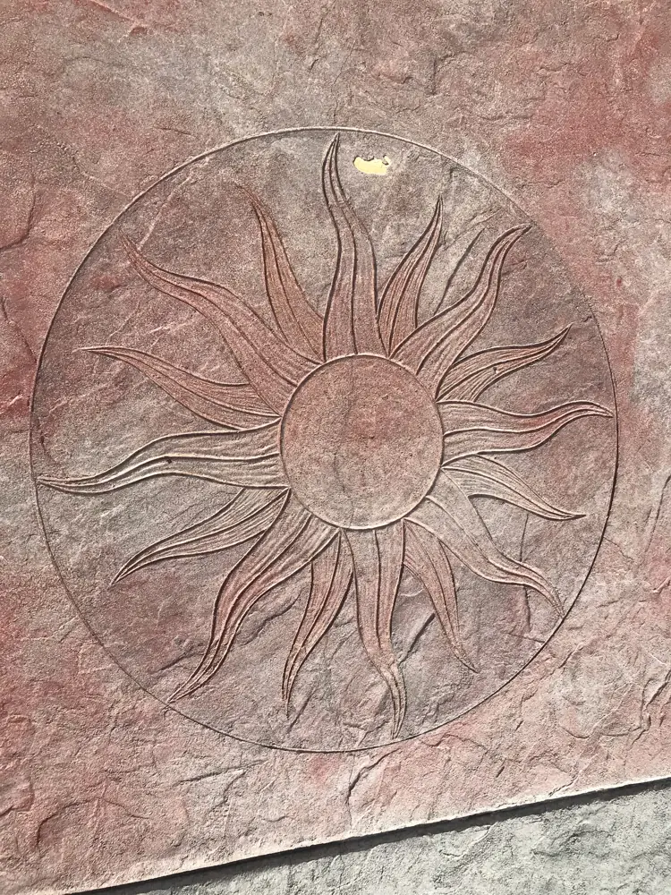 Stamped medallion detail in coloured concrete